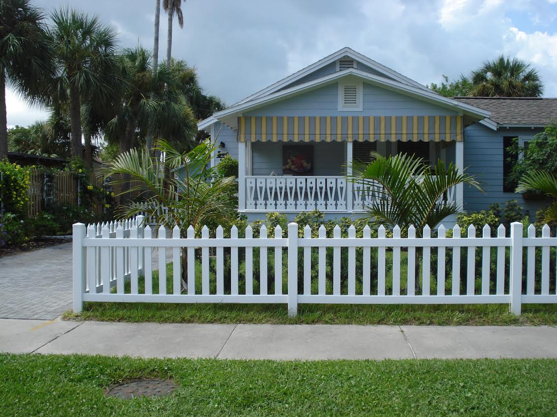 Small blue house with white picket fence