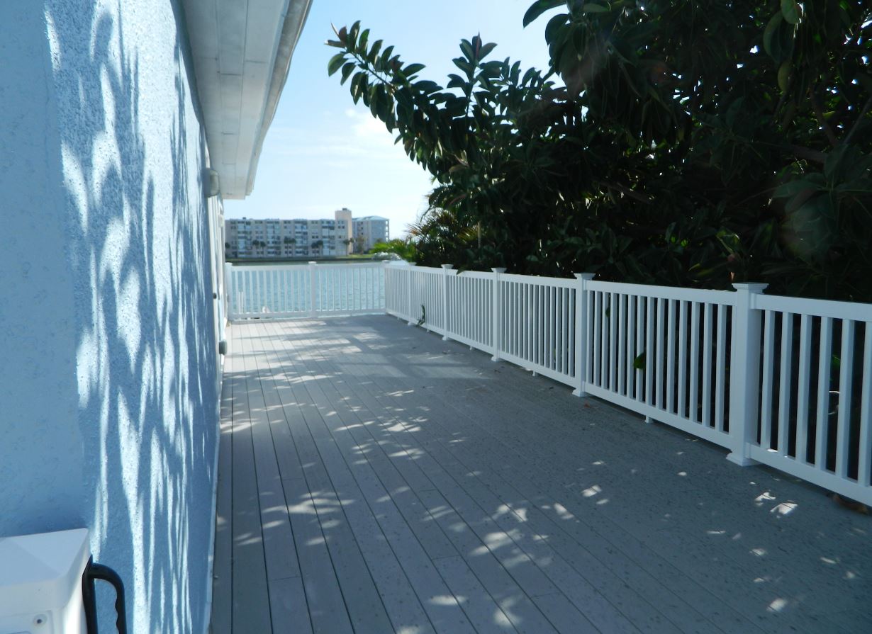 Spacious waterfront deck with white railing