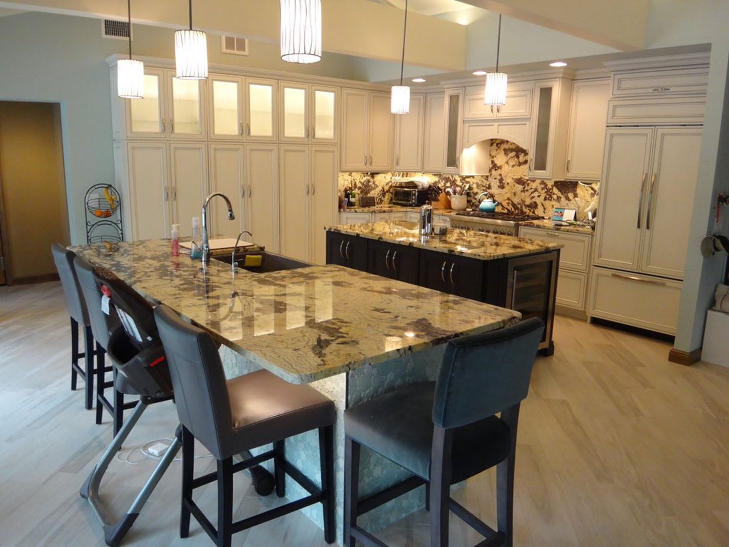 Modern kitchen with granite island and stools