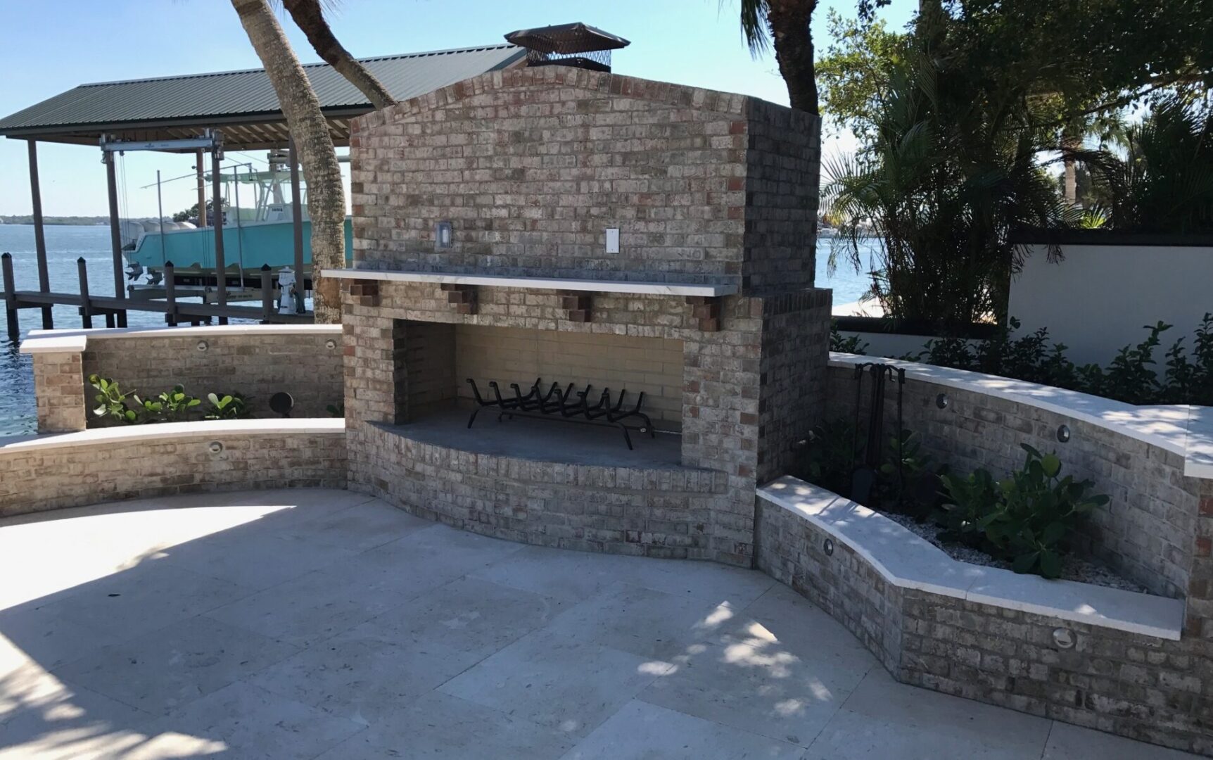 Waterfront outdoor brick fireplace with curved seating