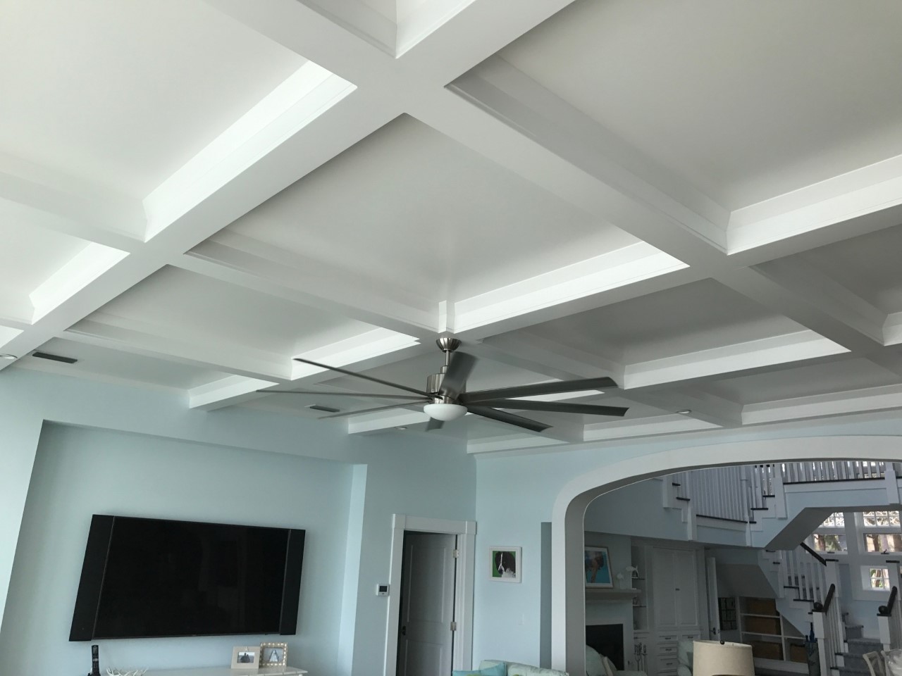 Living room with coffered ceiling and fan