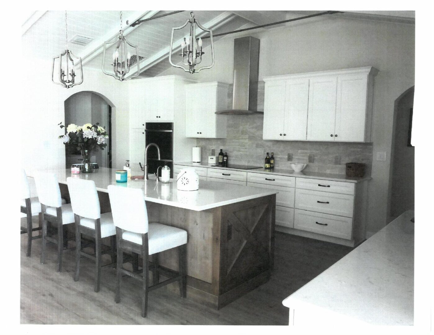 Modern kitchen island with stools and pendants