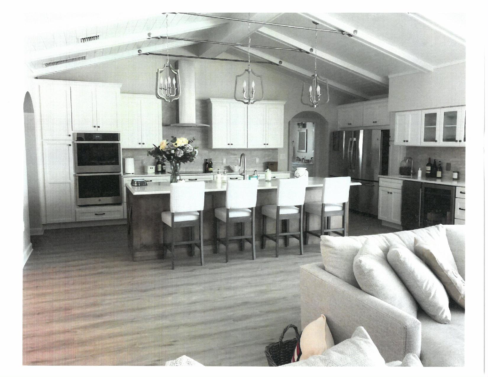 Open plan kitchen with island and bar stools