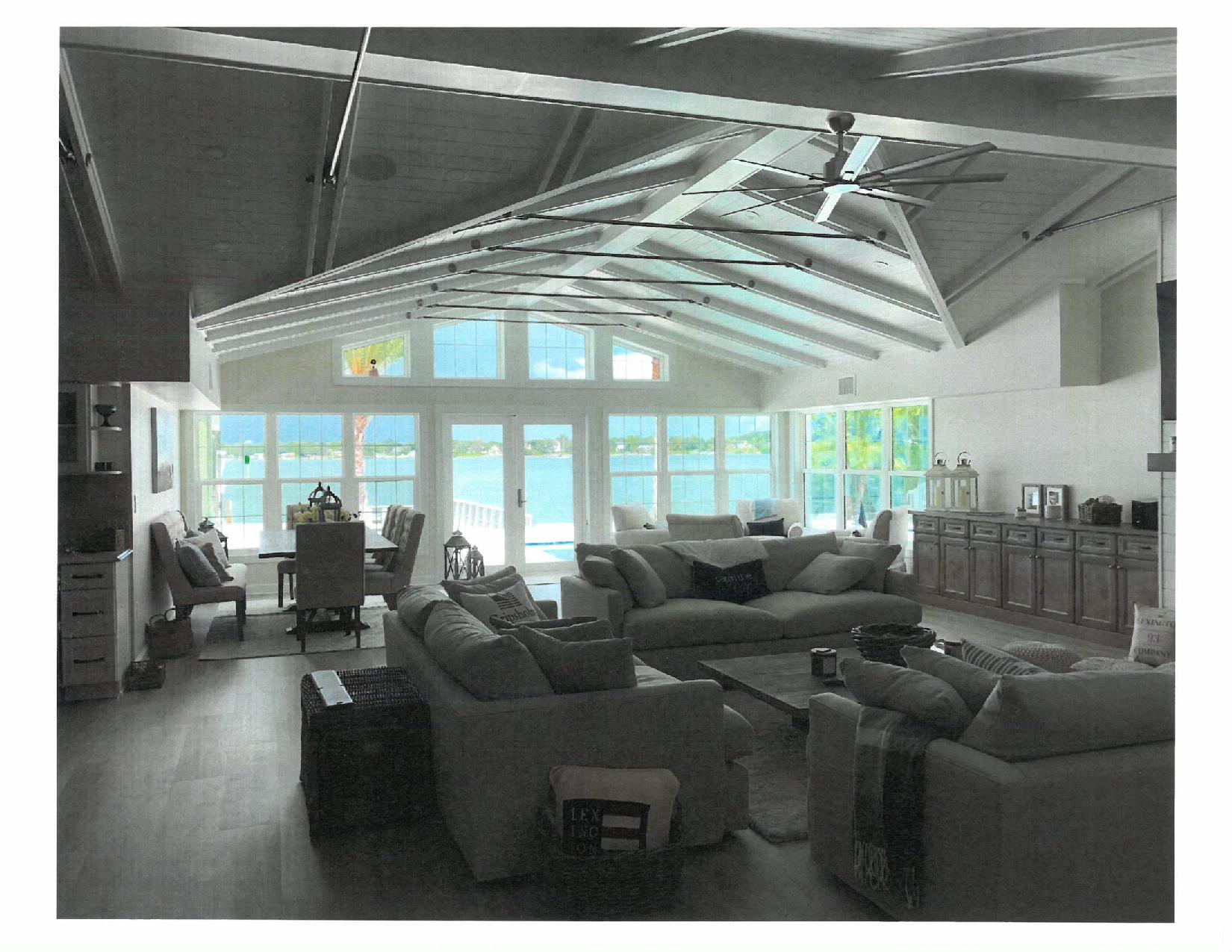 Lake-view living room with vaulted beamed ceiling