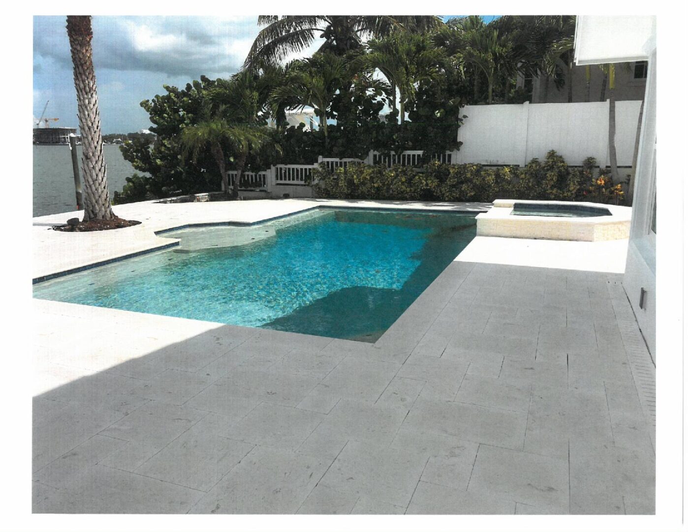 Modern backyard pool with spa and palms