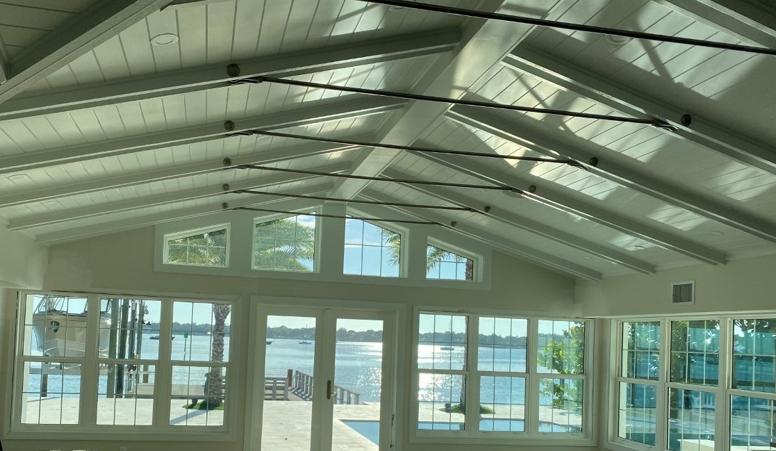 Sunlit room with vaulted ceiling and waterfront view