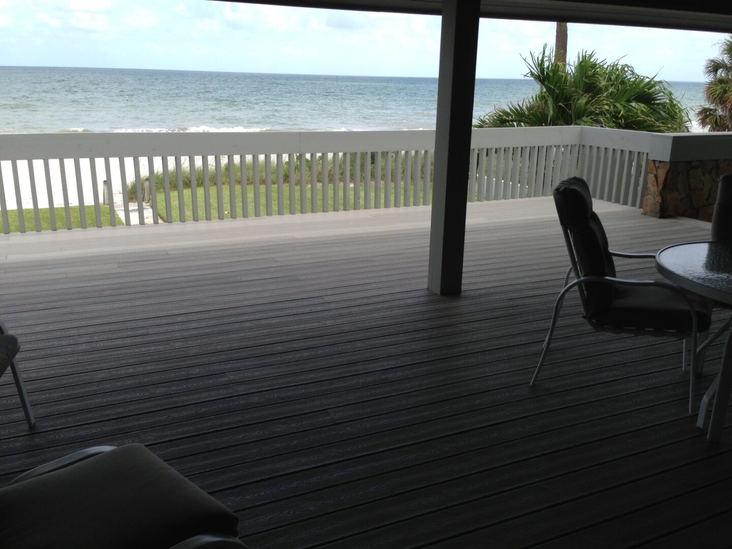 Covered beachfront deck with table and chairs