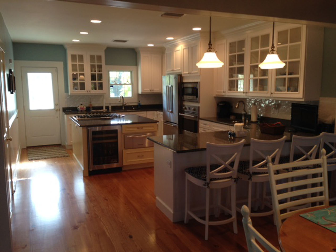 Modern white kitchen with island and stainless appliances