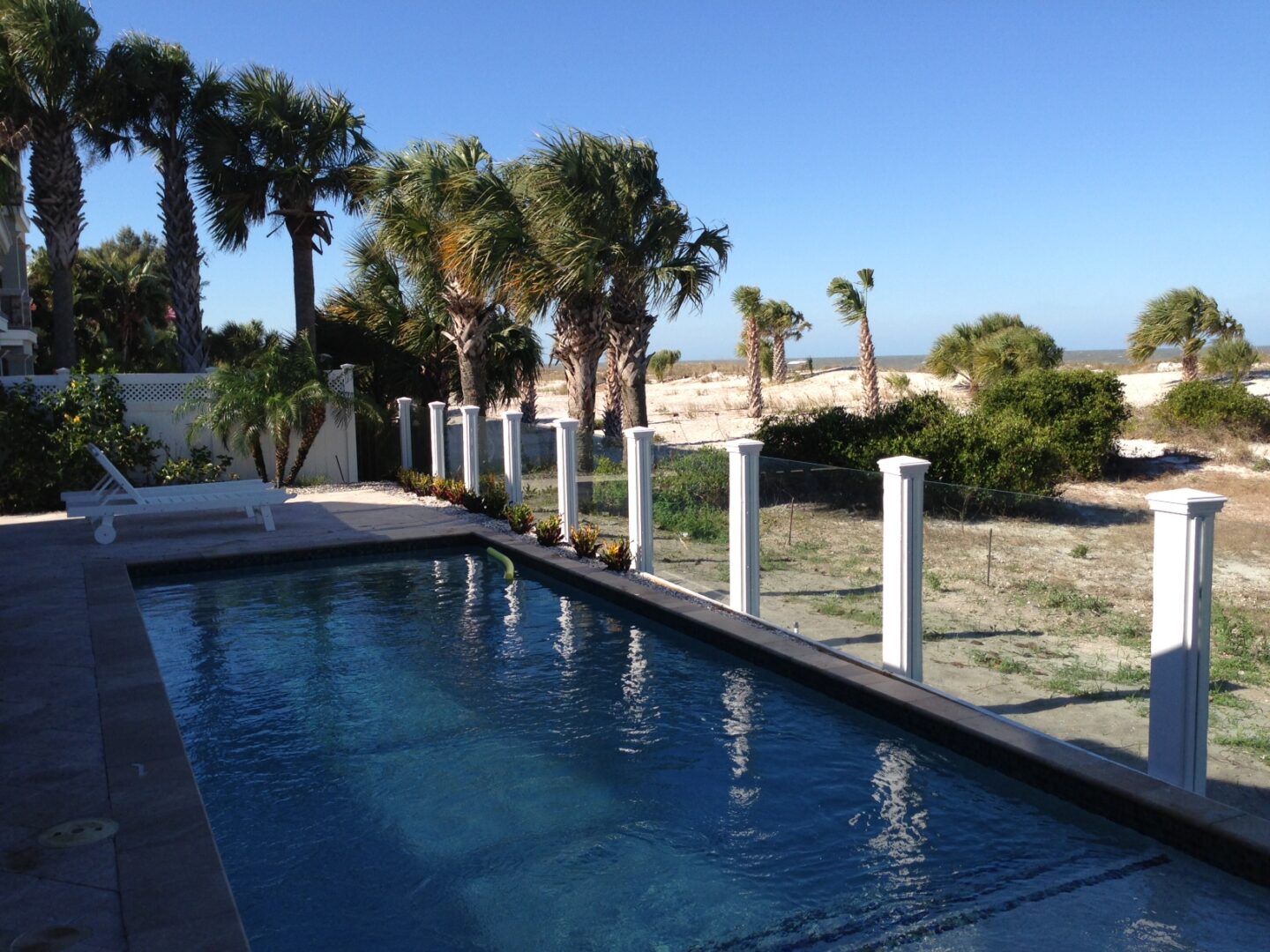 Oceanfront pool with palm trees and beach
