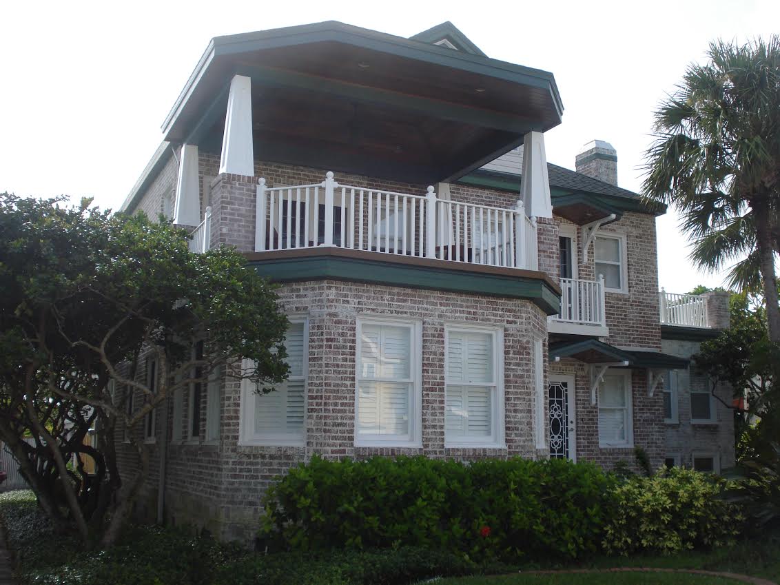 Two-story brick house with covered balcony