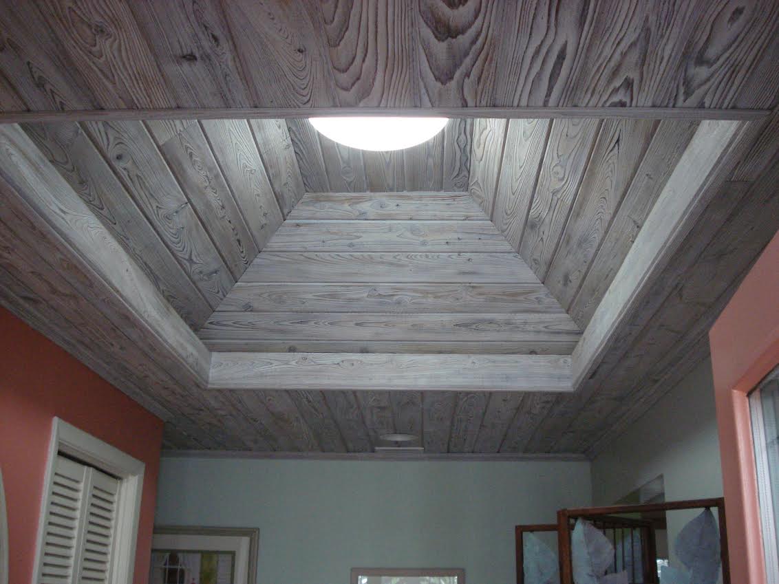 Wood-paneled recessed ceiling with round light