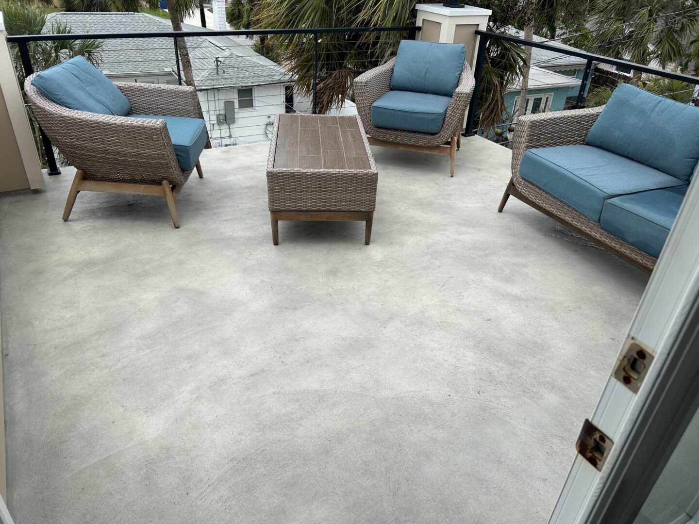 Rooftop patio with wicker seating and table