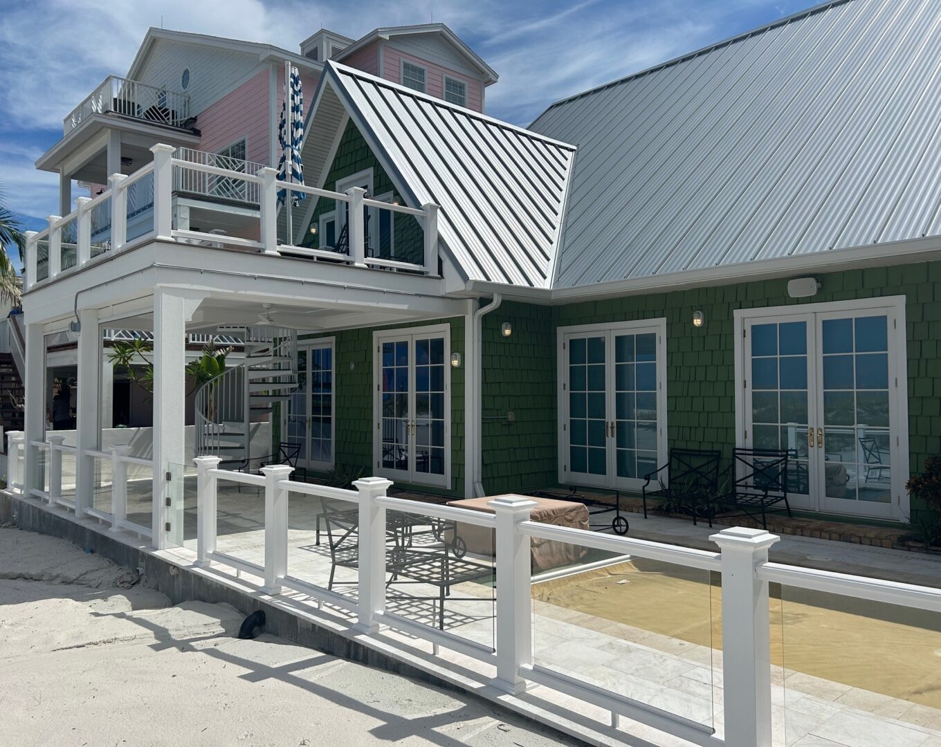 Green beach house with balconies and railing