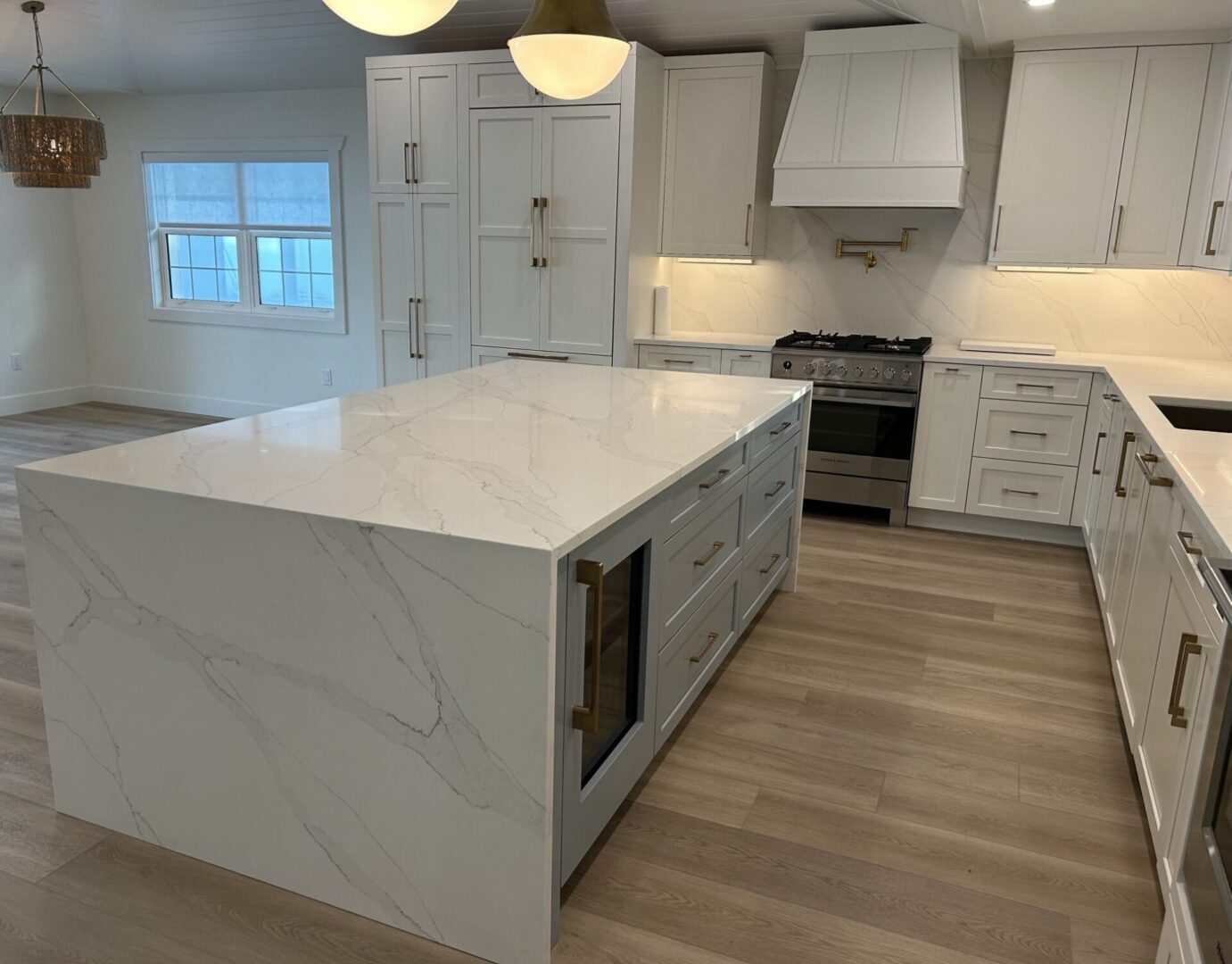 Modern white kitchen with large marble island