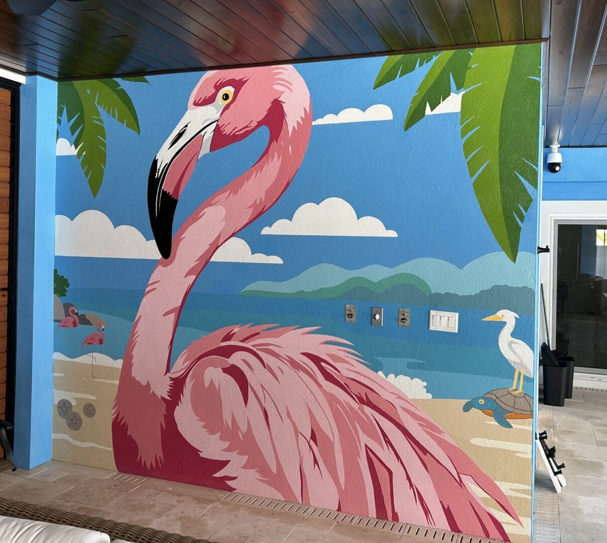 Pink flamingo mural on tropical beach wall
