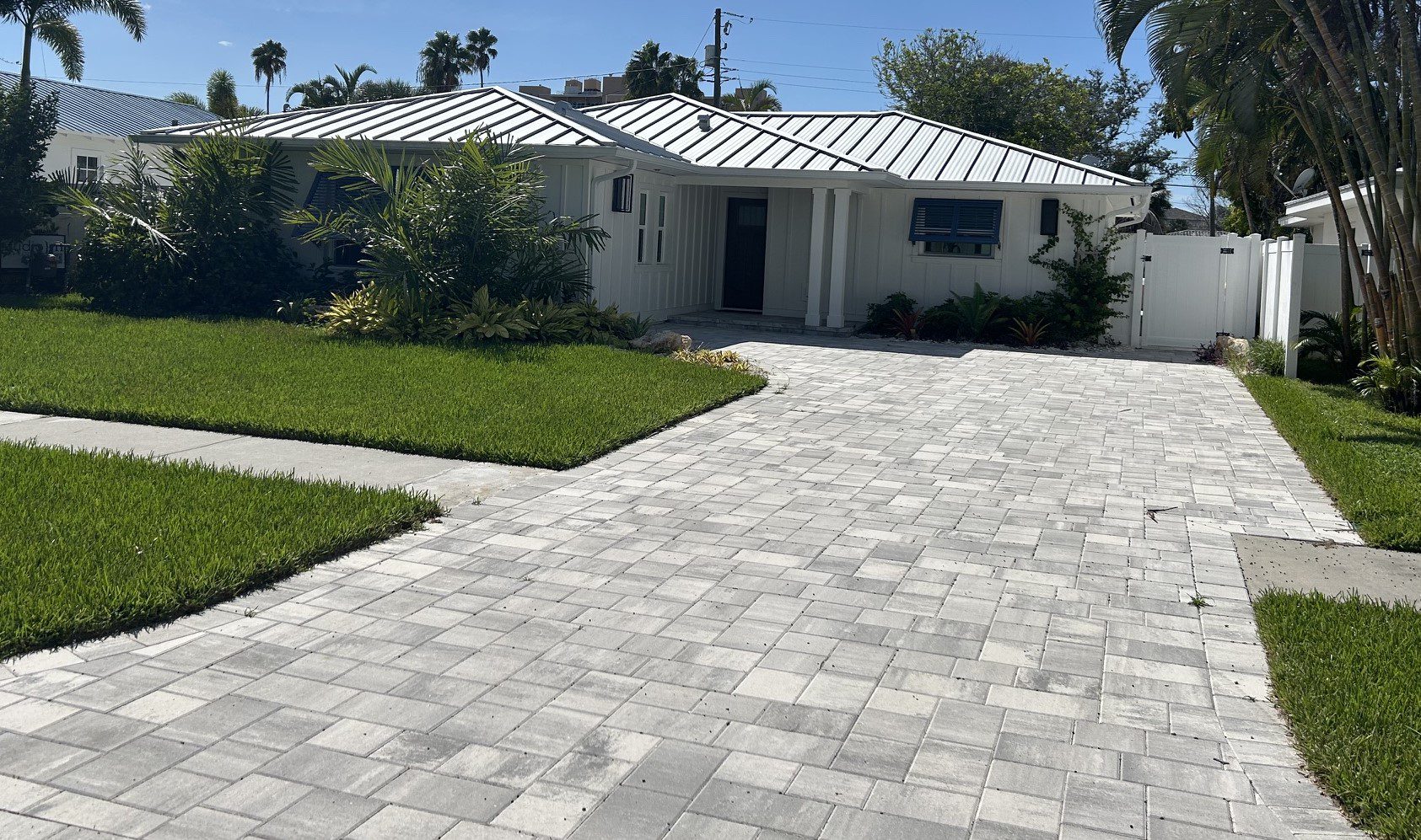 Single-story white house with paved driveway
